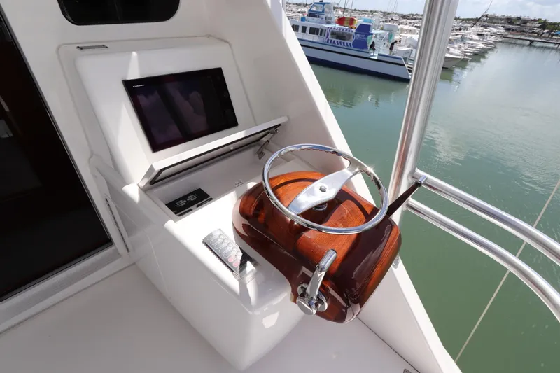 Stress Release Yacht Photos Pics 2017 Viking 80 Enclosed Bridge helm with steering wheel and control panel.