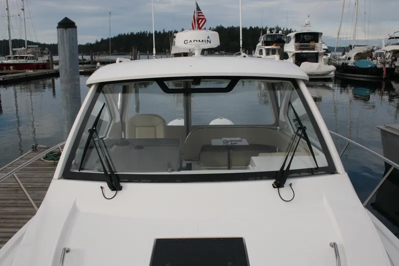  Yacht Photos Pics 2021 Pursuit OS 325 Offshore boat docked at marina with Garmin equipment.