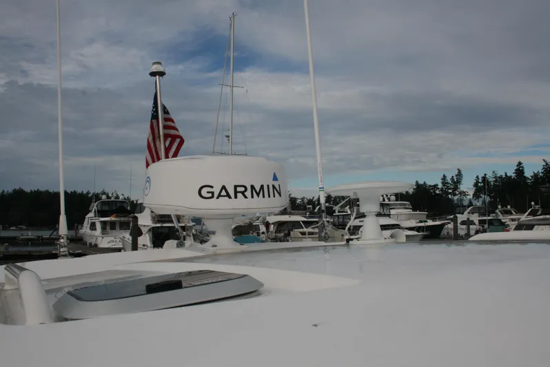  Yacht Photos Pics 2021 Pursuit OS 325 Offshore boat with Garmin radar and American flag in marina.