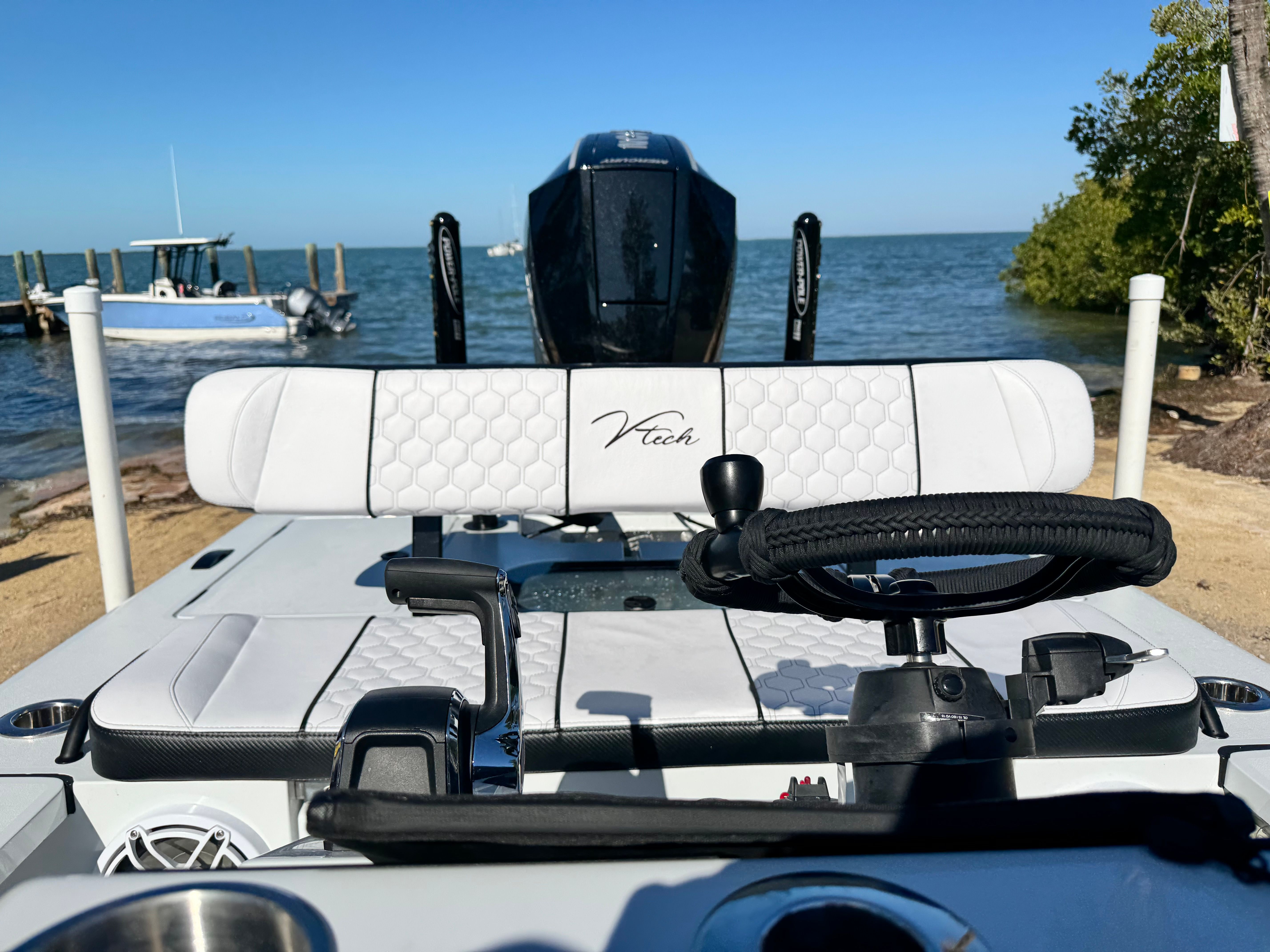 Vtech 18 FLATS boat, helm view, at beach, 2026 model.