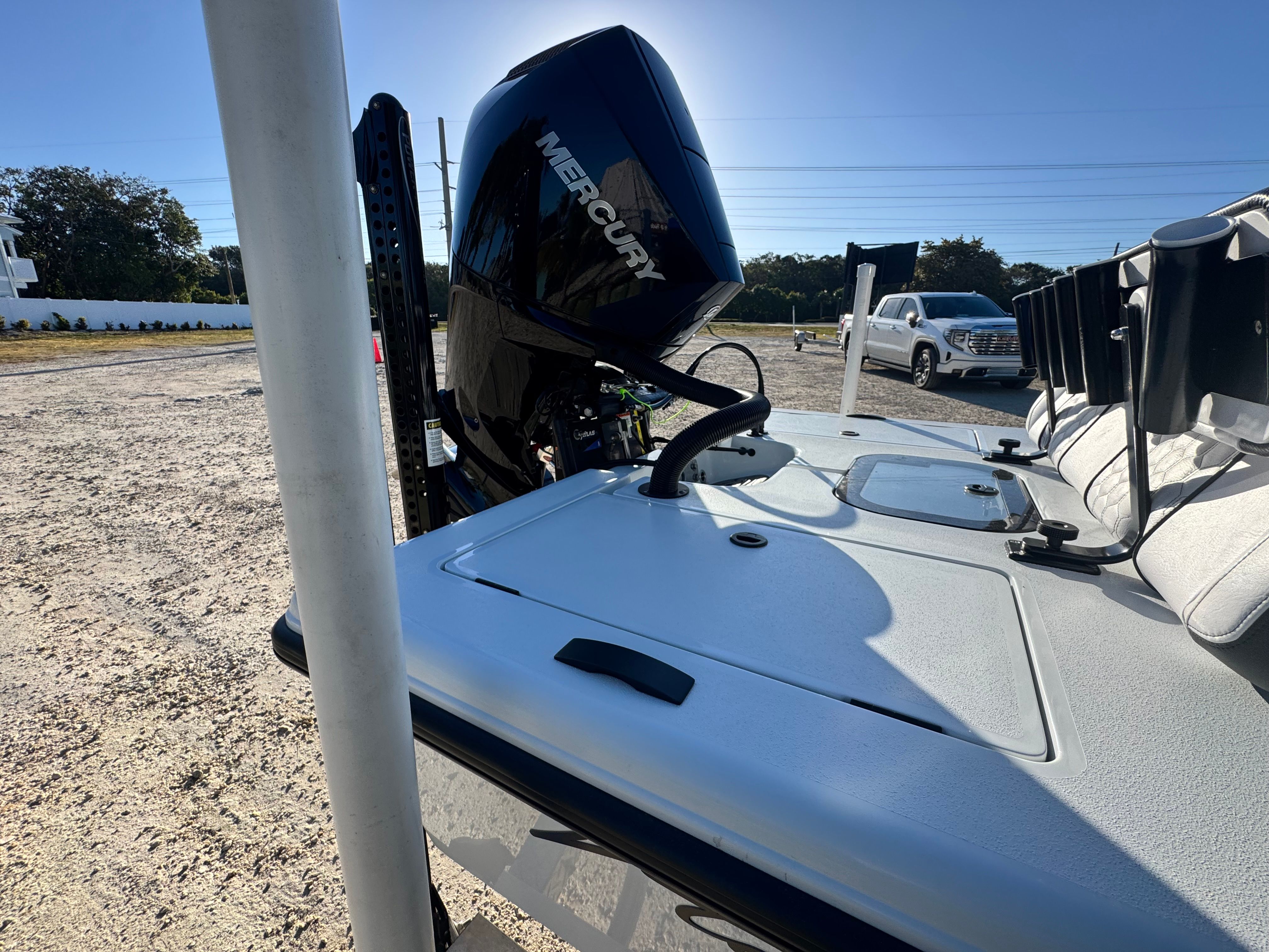 Vtech 18 FLATS 2026 boat with Mercury engine on parking lot.