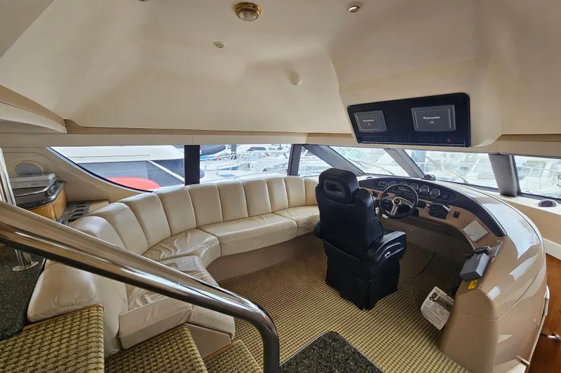 Paradox Yacht Photos Pics Luxurious interior of 2000 Carver 530 Voyager Pilothouse yacht with helm and seating area.