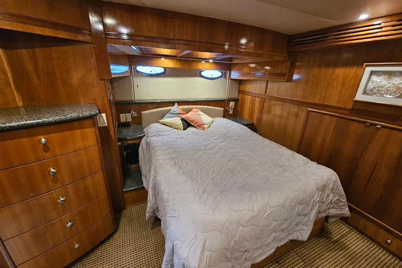 Paradox Yacht Photos Pics Luxurious cabin interior of 2000 Carver 530 Voyager Pilothouse yacht with wood paneling.