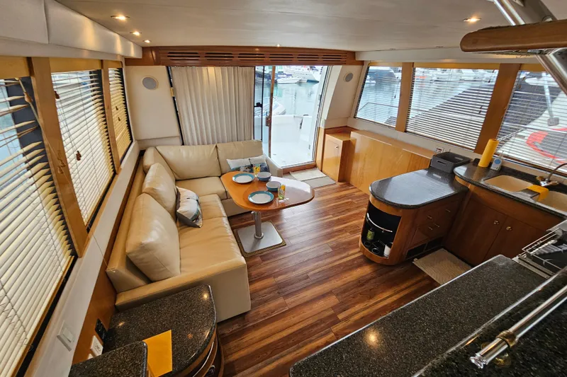 Paradox Yacht Photos Pics Luxurious interior of 2000 Carver 530 Voyager Pilothouse with elegant seating and dining area.