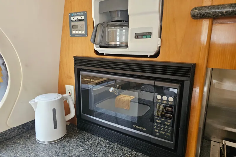 Paradox Yacht Photos Pics Kitchen appliances in a 2000 Carver 530 Voyager Pilothouse, featuring a microwave, coffee maker, and kettle.