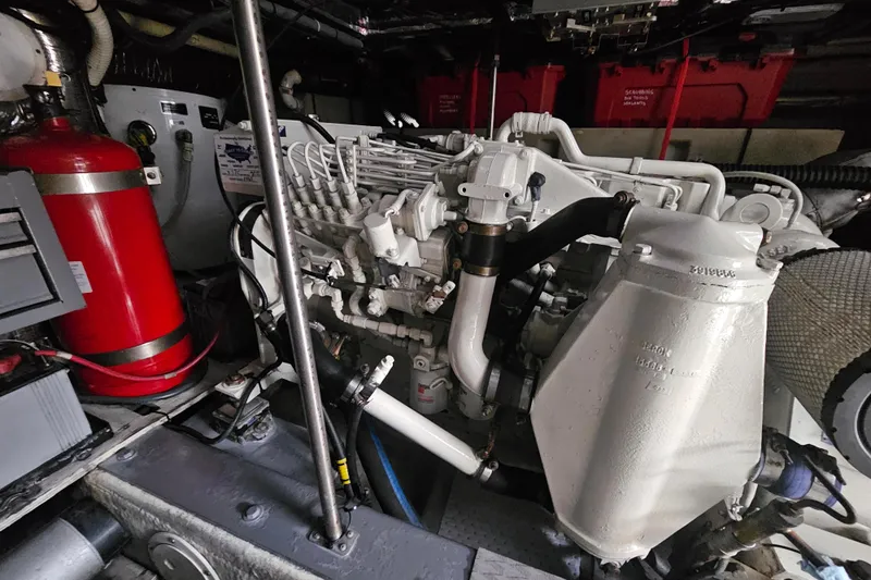 Paradox Yacht Photos Pics Engine room of 2000 Carver 530 Voyager Pilothouse with visible machinery and fire extinguisher.