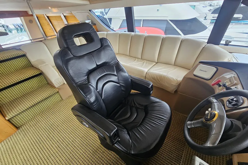 Paradox Yacht Photos Pics Luxurious interior of 2000 Carver 530 Voyager Pilothouse with leather seating and helm.