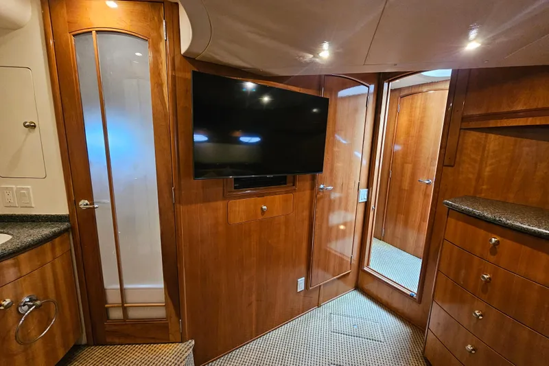 Paradox Yacht Photos Pics Interior of 2000 Carver 530 Voyager Pilothouse with wood paneling and mounted TV.