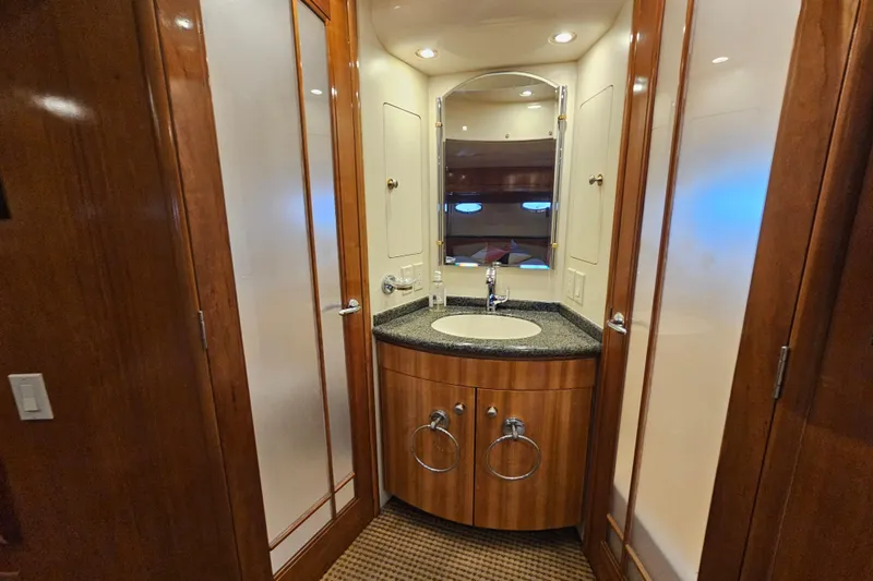 Paradox Yacht Photos Pics Luxurious bathroom in 2000 Carver 530 Voyager Pilothouse yacht with wood accents and modern fixtures.