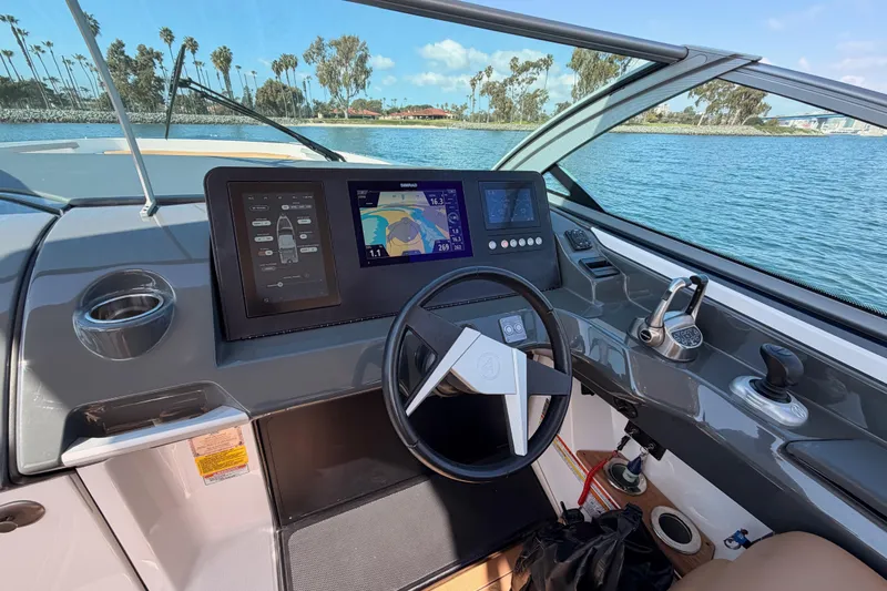 Wonder Why Yacht Photos Pics 2022 Aviara AV32 I/O boat dashboard with navigation screens, steering wheel, and water view.