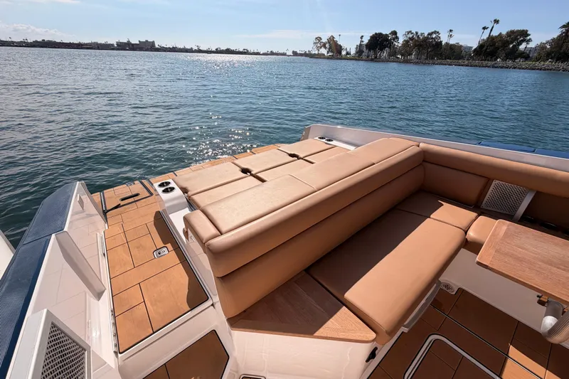 Wonder Why Yacht Photos Pics 2022 Aviara AV32 I/O boat with tan seating, docked on calm water.
