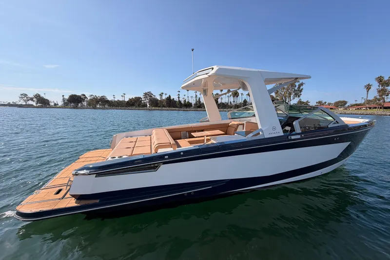 Wonder Why Yacht Photos Pics 2022 Aviara AV32 I/O boat on calm water, featuring sleek design and spacious seating.