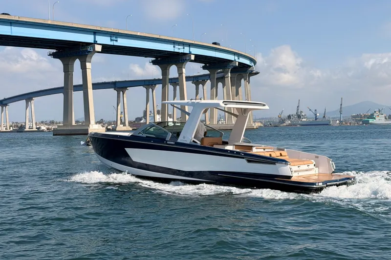 Wonder Why Yacht Photos Pics 2022 Aviara AV32 I/O boat cruising under a bridge on a sunny day.