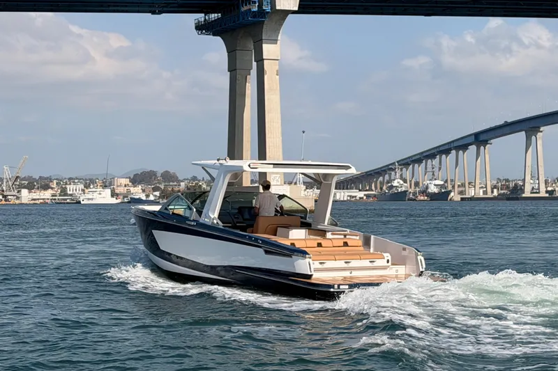 Wonder Why Yacht Photos Pics 2022 Aviara AV32 I/O boat cruising under a bridge on a sunny day.
