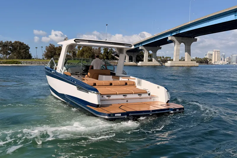 Wonder Why Yacht Photos Pics 2022 Aviara AV32 I/O boat cruising under a bridge on a sunny day.