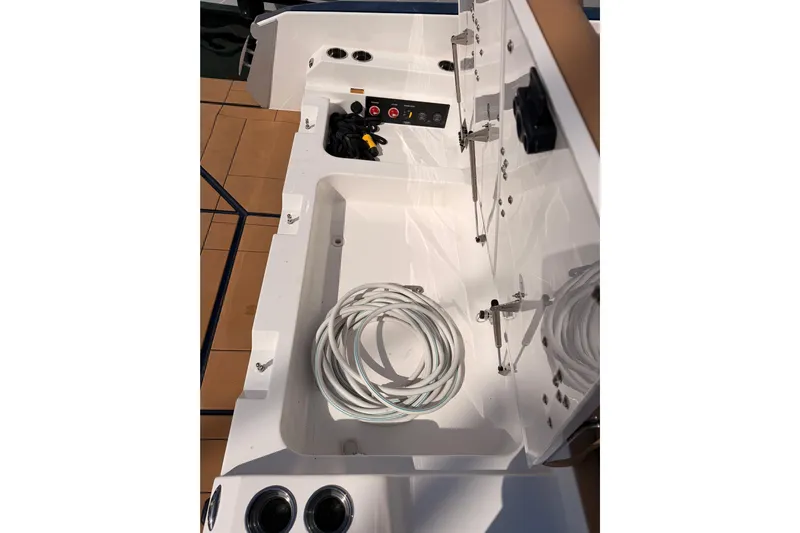 Wonder Why Yacht Photos Pics 2022 Aviara AV32 I/O boat storage compartment with coiled cables and control panel.