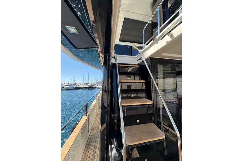  Yacht Photos Pics 2022 Cranchi T55 Trawler yacht with exterior stairs and marina view.