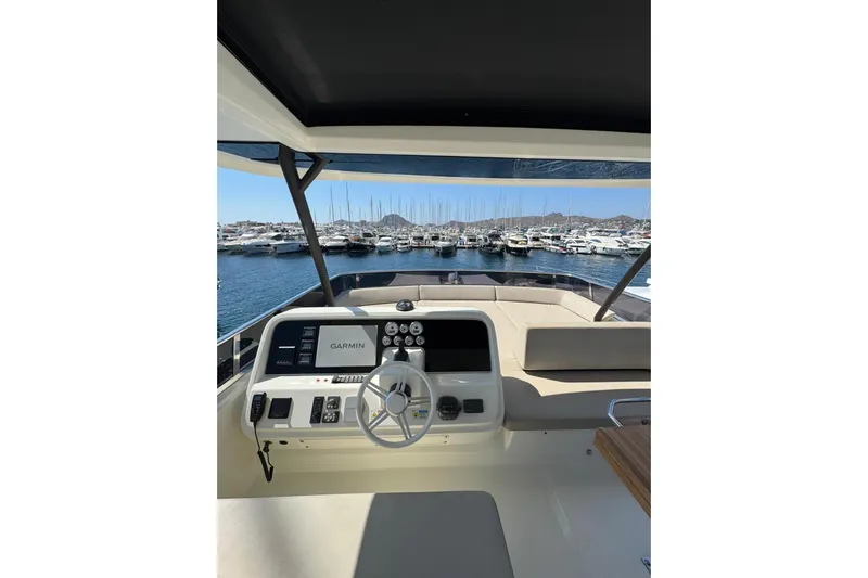  Yacht Photos Pics 2022 Cranchi T55 Trawler helm with Garmin navigation, overlooking marina.