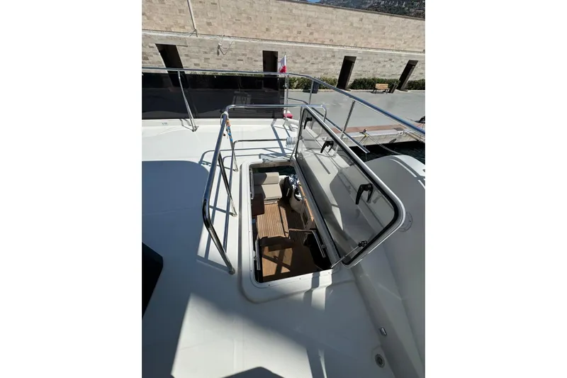  Yacht Photos Pics 2022 Cranchi T55 Trawler deck with open hatch and railing.
