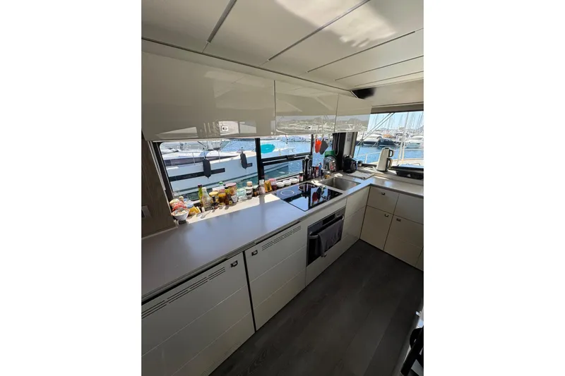  Yacht Photos Pics Modern kitchen interior of 2022 Cranchi T55 Trawler with marina view.