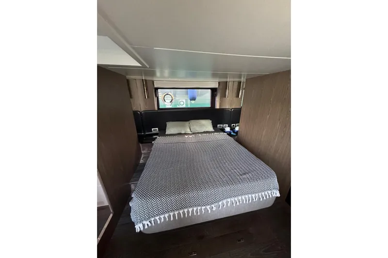  Yacht Photos Pics Interior cabin of 2022 Cranchi T55 Trawler with cozy bed and window view.