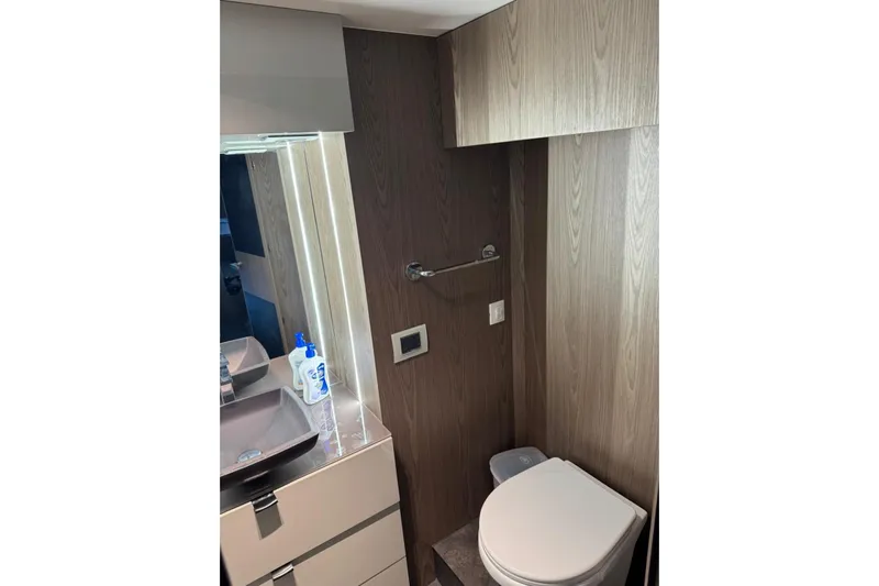  Yacht Photos Pics Bathroom interior of 2022 Cranchi T55 Trawler with modern fixtures and wood paneling.