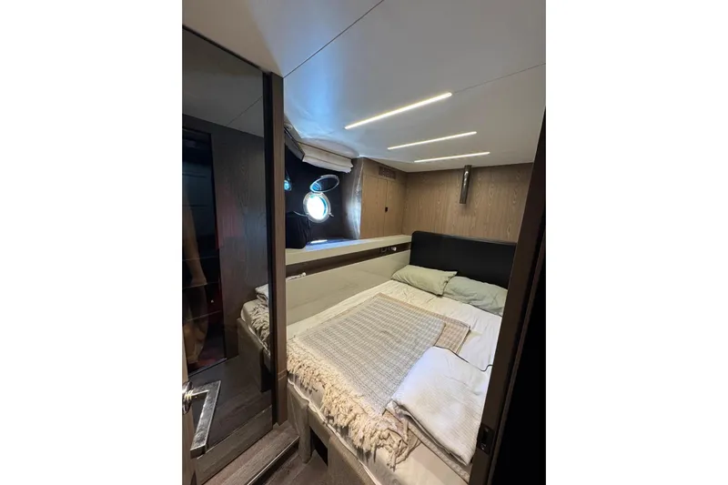  Yacht Photos Pics Luxurious cabin interior of 2022 Cranchi T55 Trawler with modern design and cozy bedding.