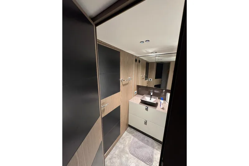  Yacht Photos Pics Modern bathroom interior of 2022 Cranchi T55 Trawler yacht, featuring sleek design and fixtures.