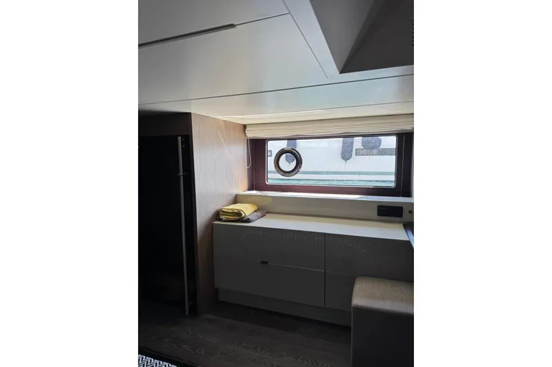  Yacht Photos Pics Interior of 2022 Cranchi T55 Trawler with window, cabinet, and folded towels.
