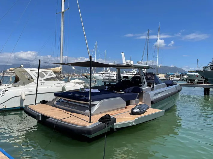  Yacht Photos Pics 2019 Wally Tender 48 yacht docked in marina under clear blue sky.