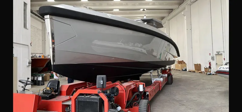  Yacht Photos Pics 2019 Wally Tender 48 yacht on red transport trailer in indoor facility.