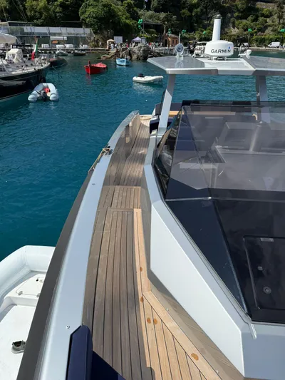  Yacht Photos Pics 2019 Wally Tender 48 yacht with sleek design, docked in a scenic marina.