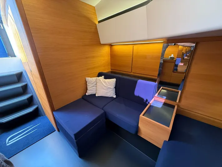  Yacht Photos Pics Luxurious interior of 2019 Wally Tender 48 yacht with blue seating and wooden accents.