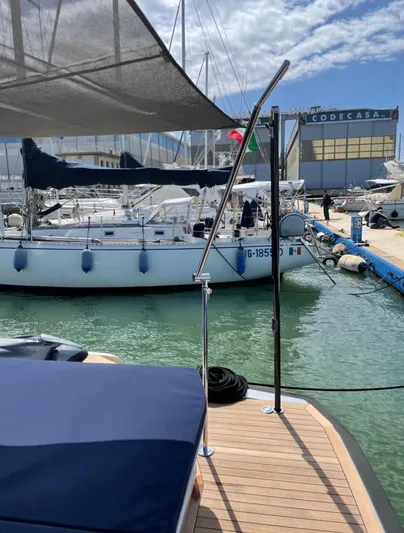  Yacht Photos Pics 2019 Wally Tender 48 docked at marina with sailboats and shipyard in background.