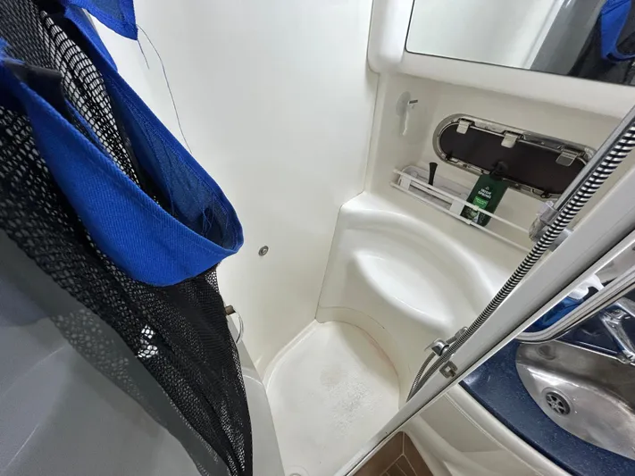  Yacht Photos Pics Sealine F44 2000 yacht bathroom with shower, sink, and storage shelves.