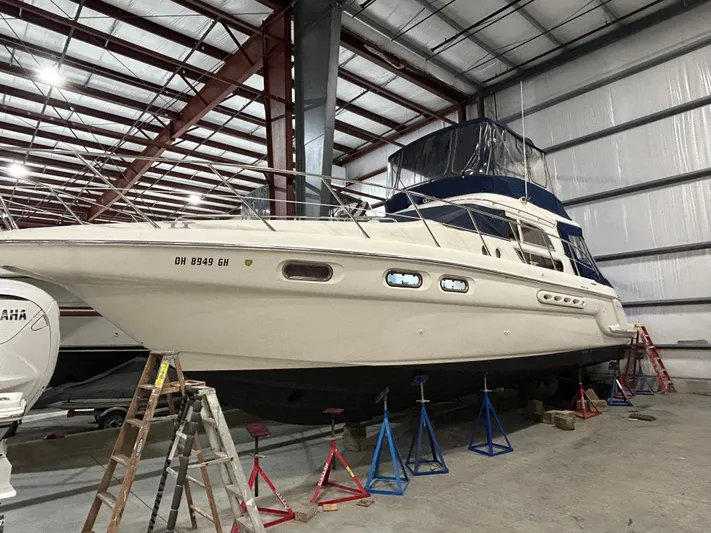  Yacht Photos Pics 2000 Sealine F44 yacht in storage, supported by stands in a warehouse.
