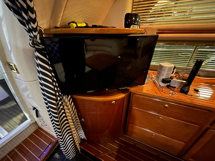  Yacht Photos Pics Interior of 2000 Sealine F44 yacht with TV and wooden cabinetry.