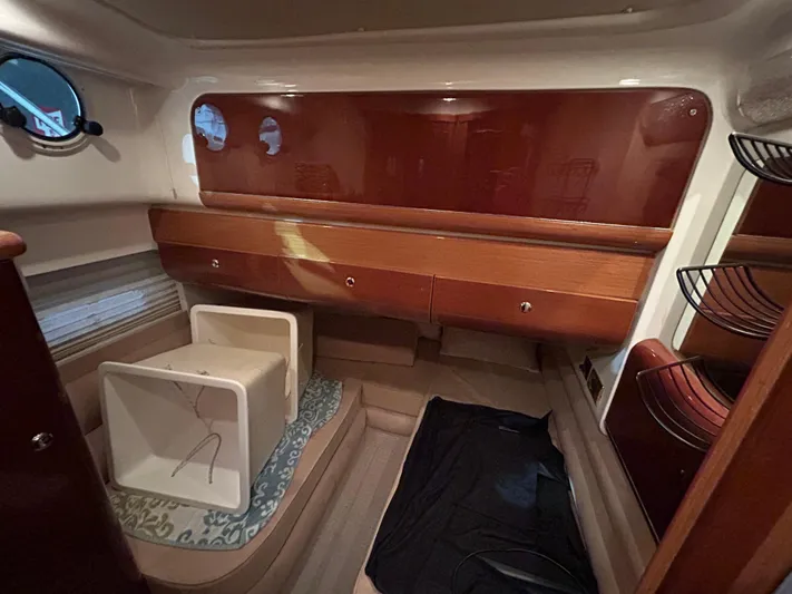  Yacht Photos Pics Interior cabin of 2000 Sealine F44 yacht with wooden cabinetry and porthole windows.