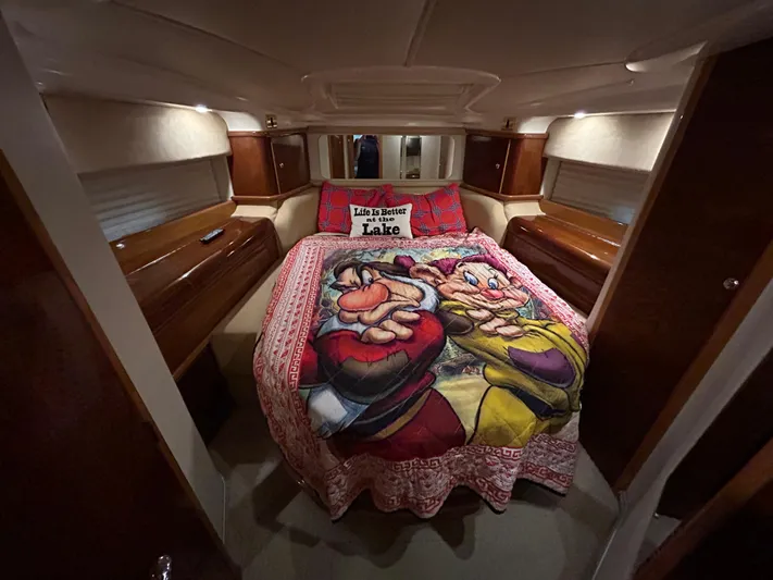  Yacht Photos Pics Cozy bedroom in 2000 Sealine F44 yacht with cartoon-themed bedding.