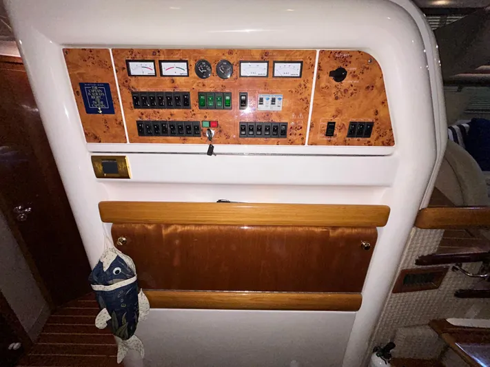  Yacht Photos Pics Control panel of a 2000 Sealine F44 yacht with wood accents and nautical decor.