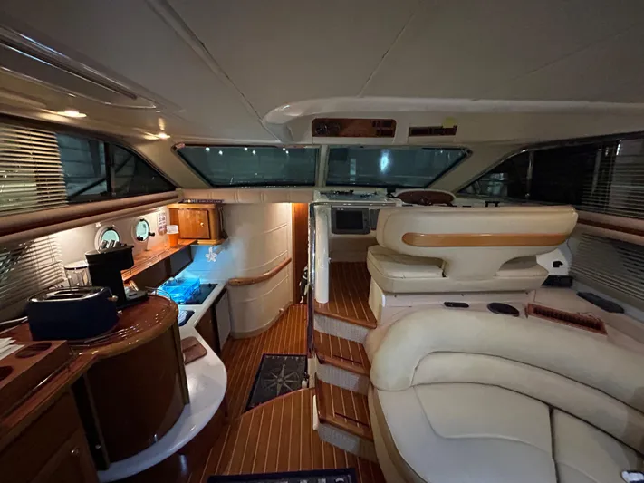  Yacht Photos Pics Interior of a 2000 Sealine F44 yacht, featuring luxurious seating and wooden finishes.