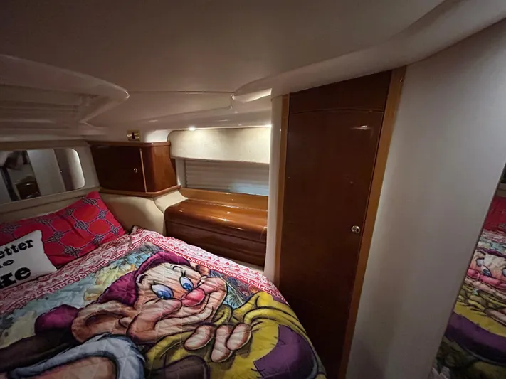 Yacht Photos Pics Cozy cabin interior of 2000 Sealine F44 yacht with colorful bedding and wooden accents.