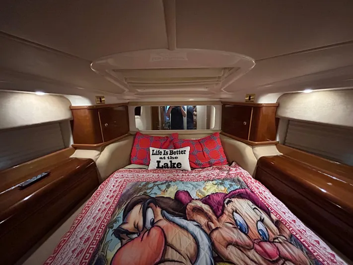 Yacht Photos Pics Luxurious cabin interior of 2000 Sealine F44 yacht with cozy bedding and decorative pillows.
