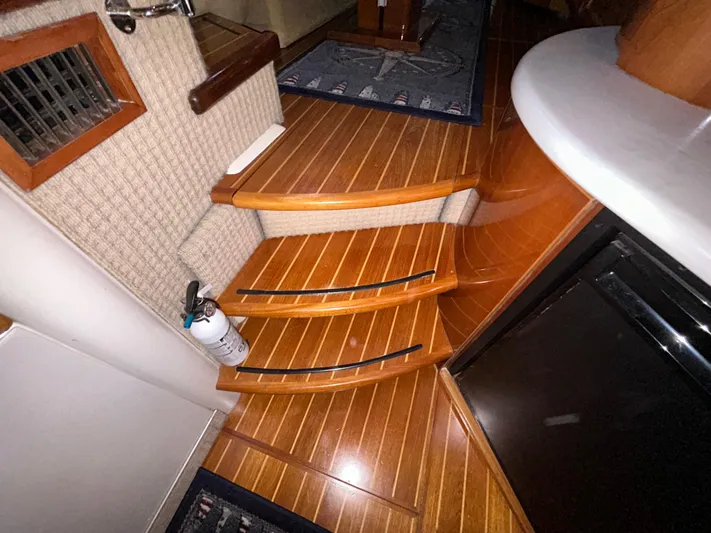  Yacht Photos Pics Interior of 2000 Sealine F44 yacht with wooden steps and fire extinguisher.