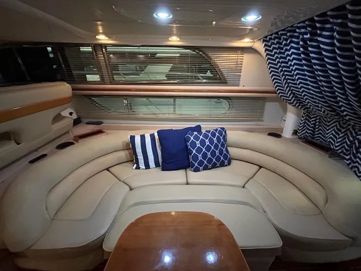  Yacht Photos Pics Luxurious interior of 2000 Sealine F44 yacht with plush seating and nautical-themed cushions.