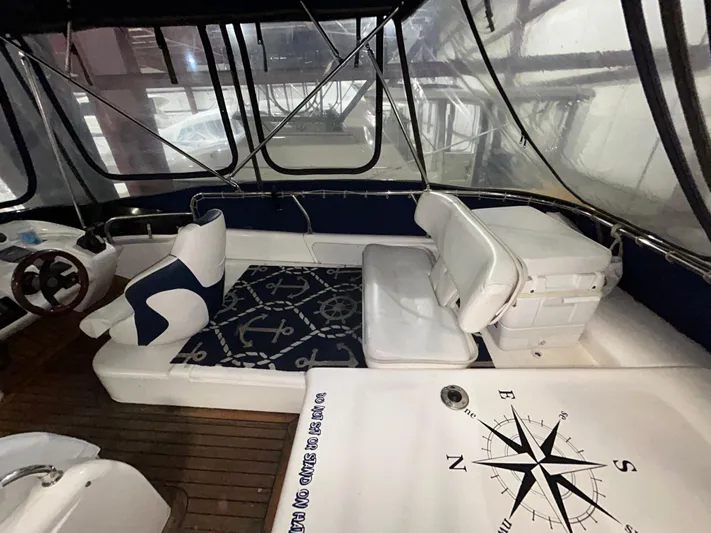  Yacht Photos Pics 2000 Sealine F44 yacht interior with compass design and cushioned seating.