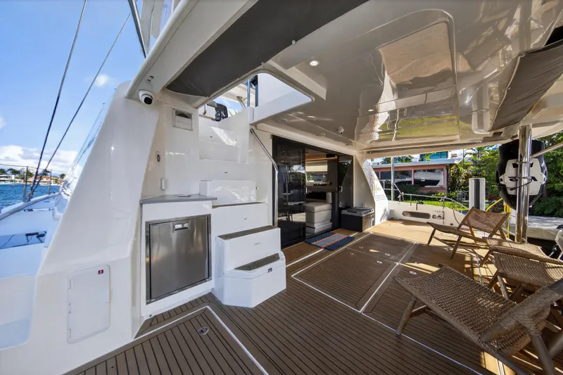  Yacht Photos Pics Luxurious 2019 Leopard 58 yacht deck with seating, modern amenities, and ocean view.