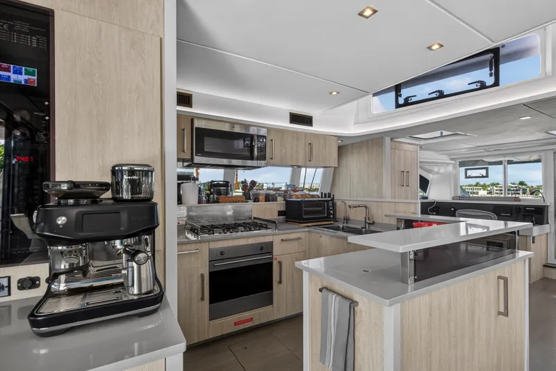  Yacht Photos Pics Luxurious kitchen interior of 2019 Leopard 58 yacht with modern appliances and sleek design.