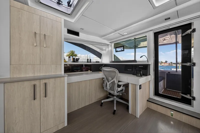  Yacht Photos Pics Modern interior of 2019 Leopard 58 yacht with sleek desk and ocean view.