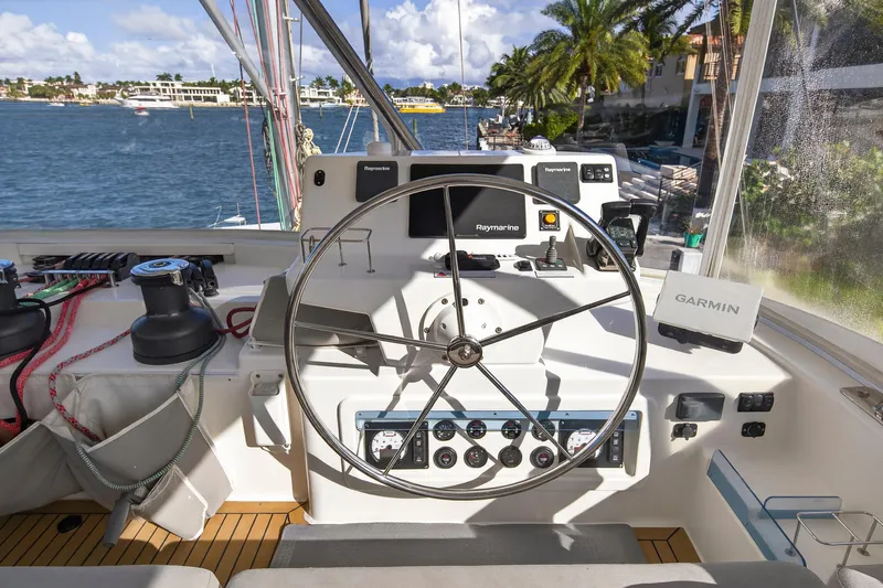  Yacht Photos Pics Helm of 2019 Leopard 58 yacht with navigation equipment and scenic waterfront view.